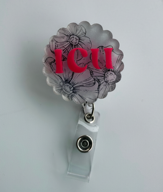 Retractable badge holder with floral design and 'ICU' text on a floral background